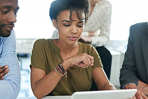 Crafting your cover letter image - Group of people viewing information on a tablet