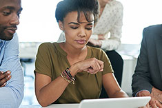 Crafting your cover letter image - Group of people viewing information on a tablet